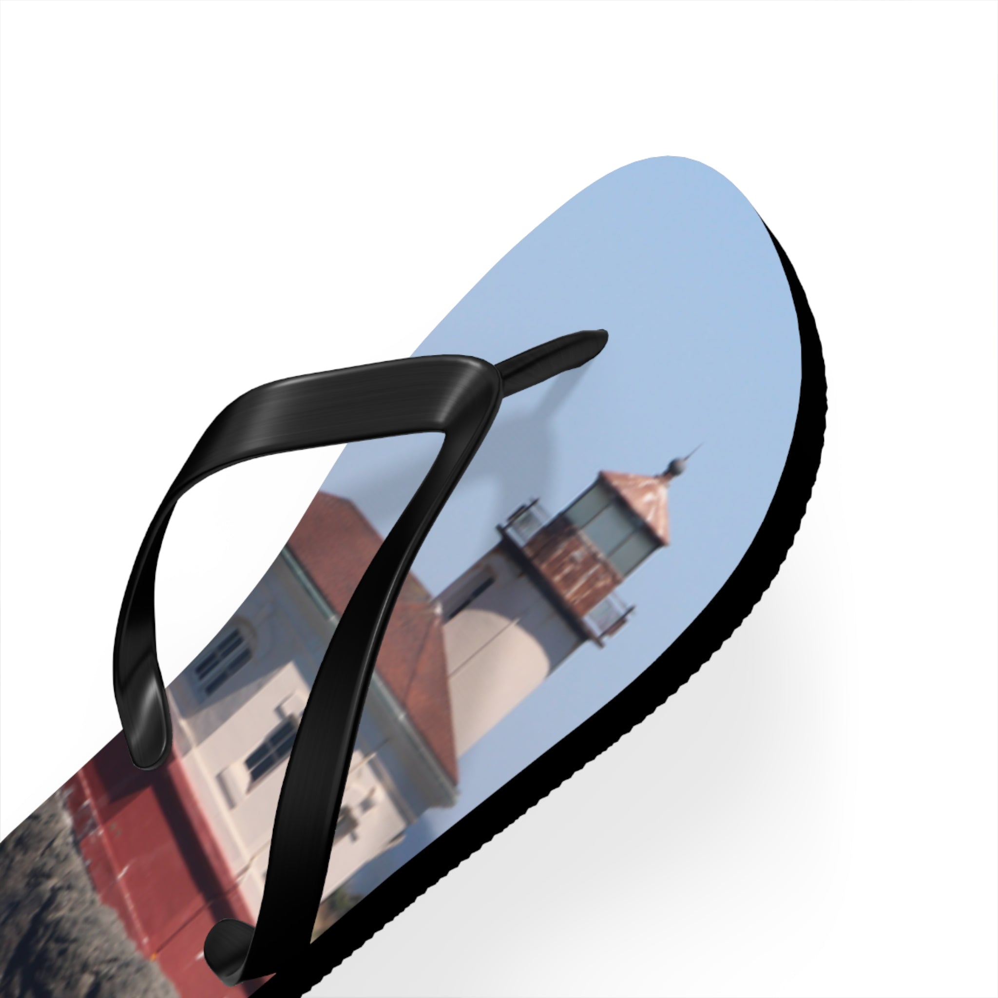 Flip-flop with a lighthouse on a bright blue sky background.