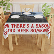 Tablecloth with red text reading "NOW THERE'S A SASQUATCH AROUND HERE SOMEWHERE".