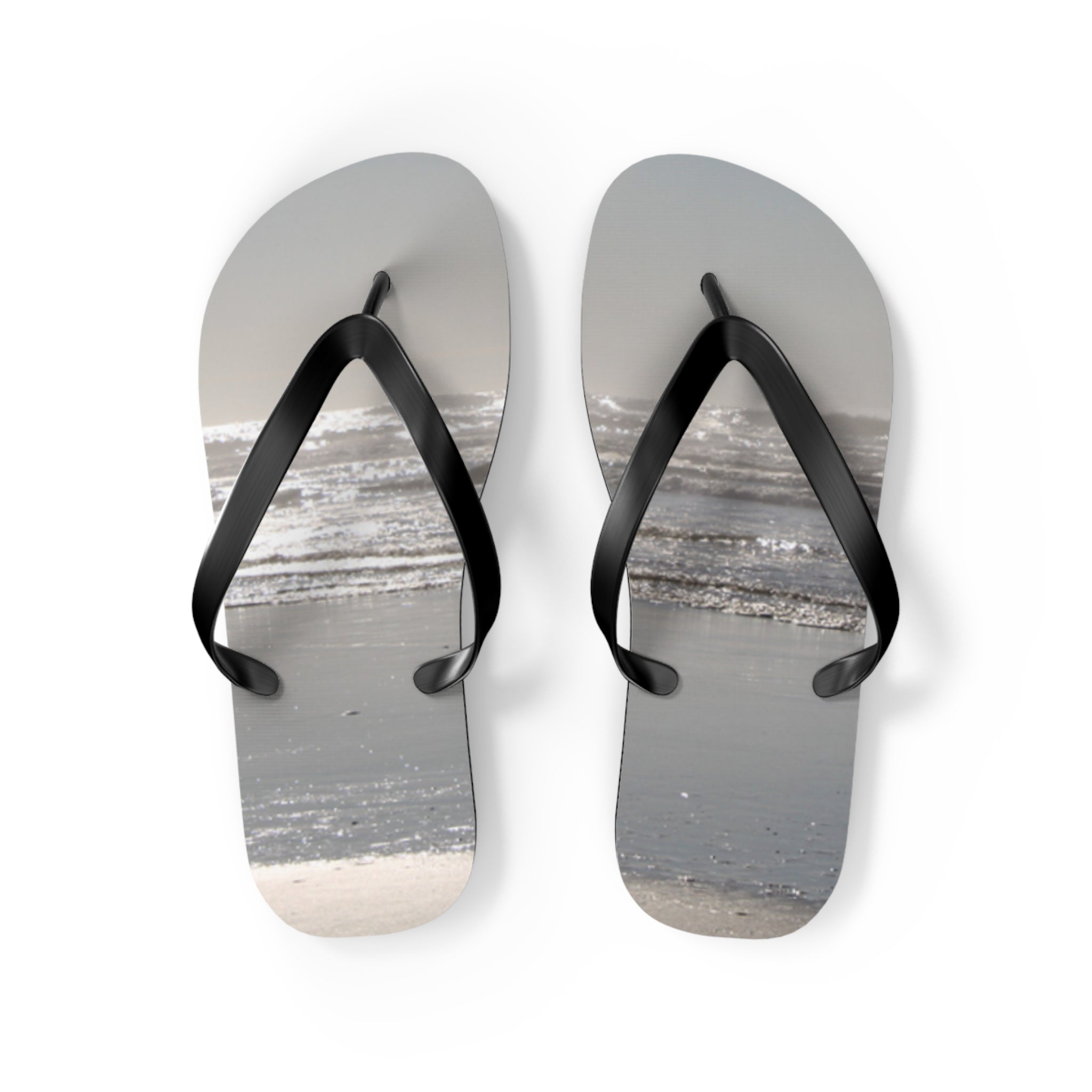 Flip-flops with a beach scene design, isolated on white.