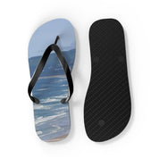 Flip-flops with beach scene and black sole, "KOREATIONFINDS.COM" text.