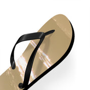 Golden flip-flop with black strap against a white background.