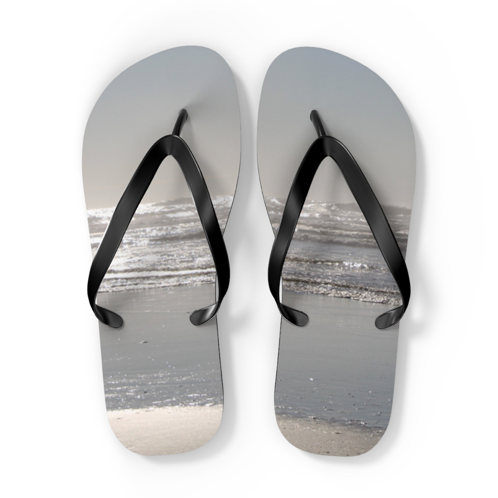 Flip-flops with a beach and ocean scene printed on them.