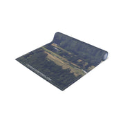 Rolled yoga mat displaying a landscape scene with "JKCREATIONFINDS.COM" text.