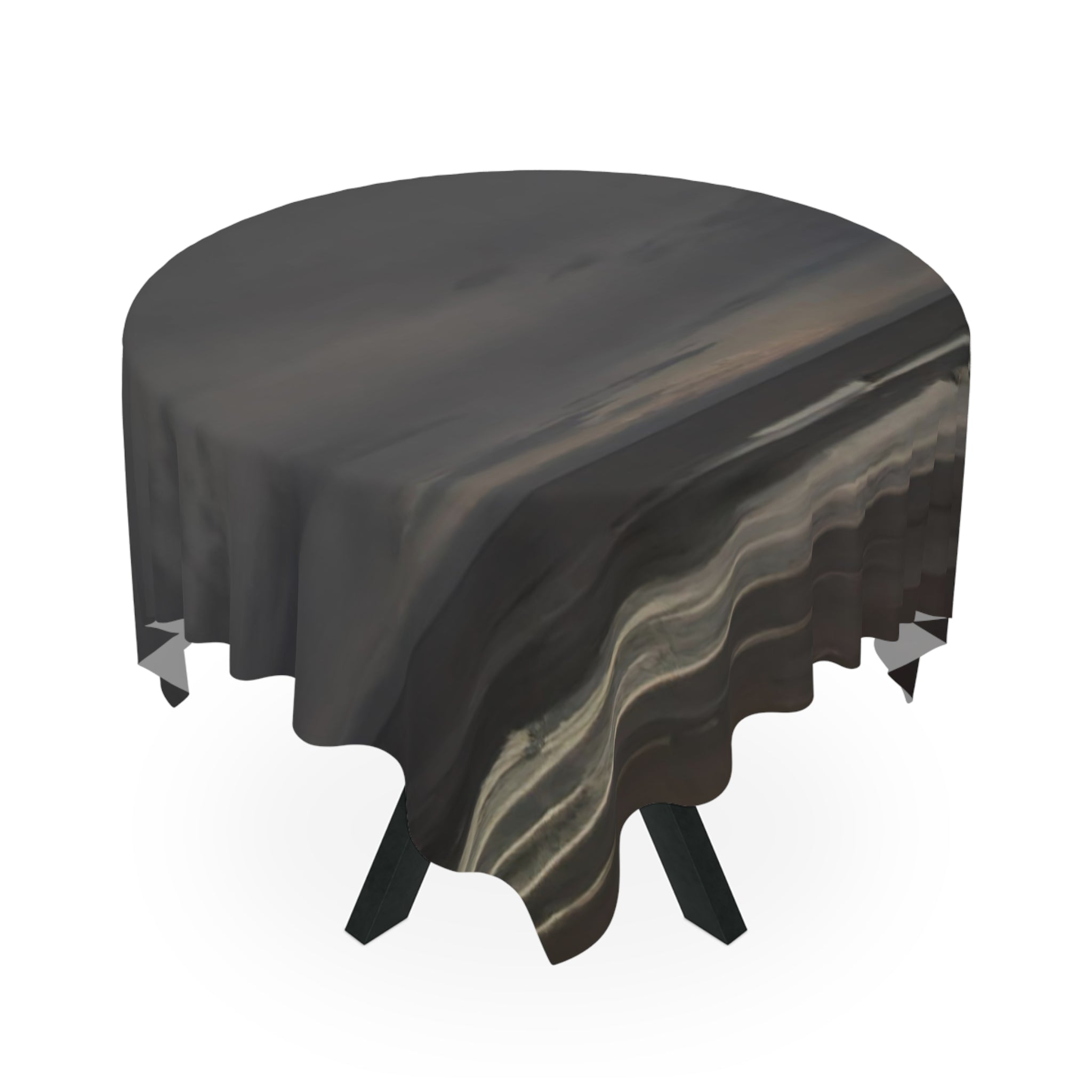 Round tablecloth with a dark abstract wave pattern over a white background.