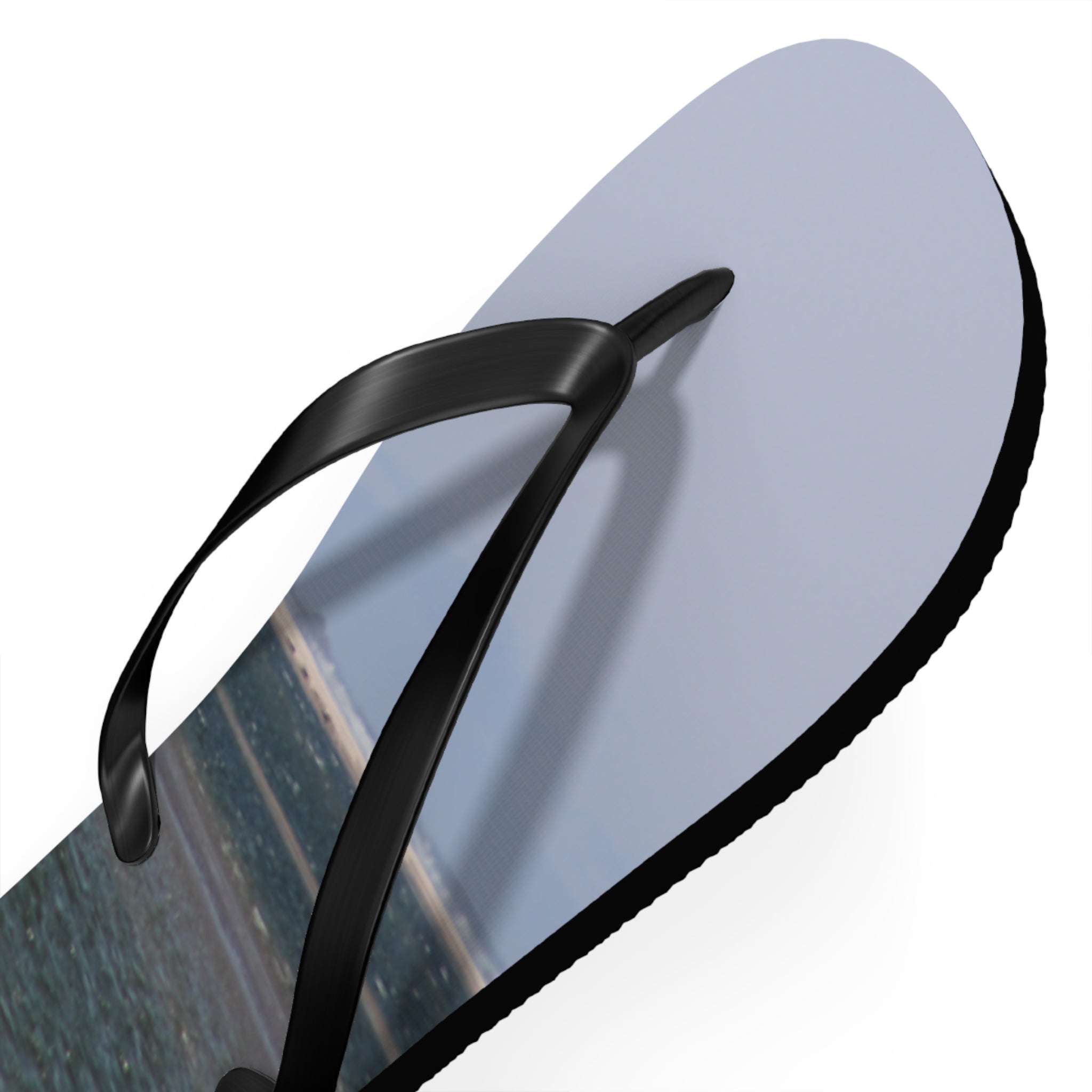 Black flip-flop with a beach scene printed on the sole.