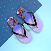 Purple flip-flops with a beach scene on the soles on a blue background.