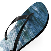 Black flip-flop with ocean wave pattern on the sole.