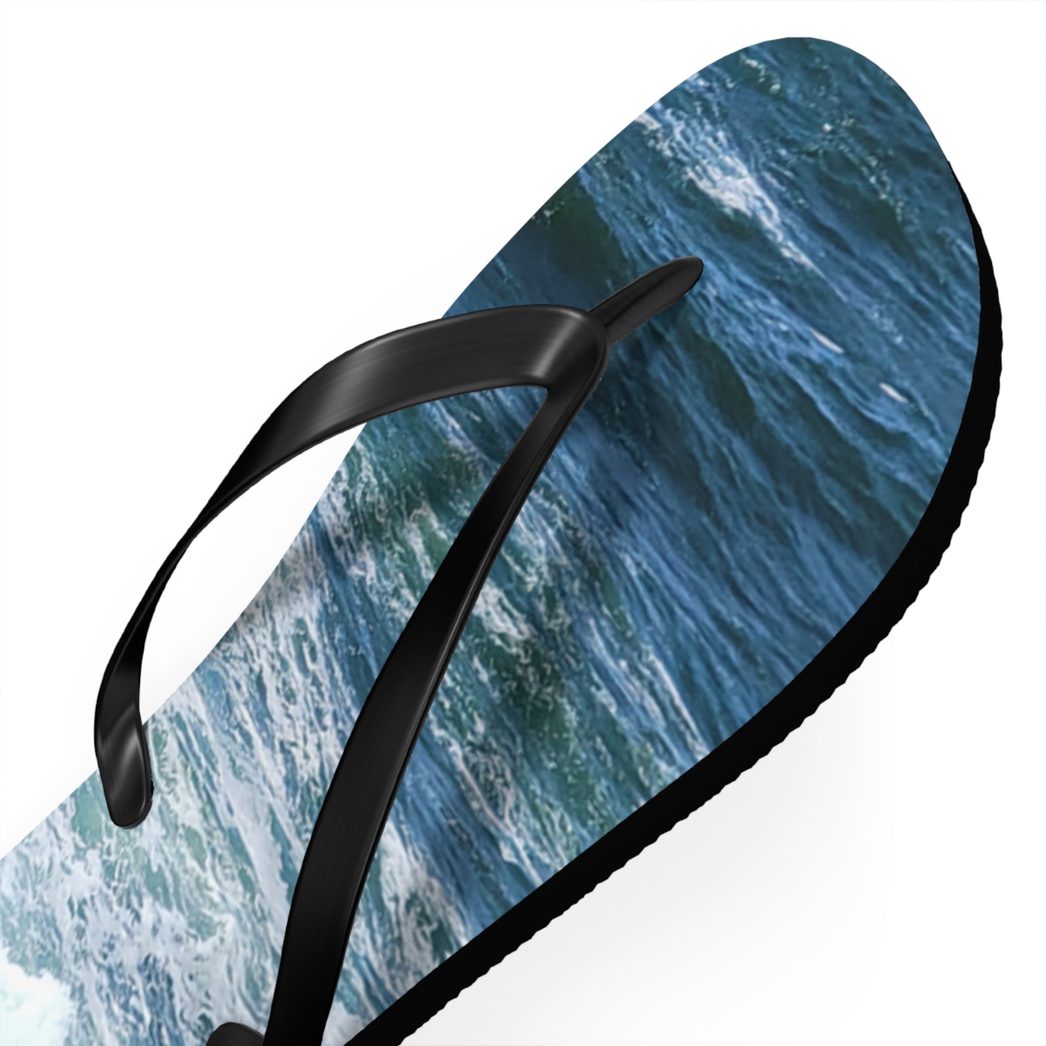 Black flip-flop with ocean wave pattern on the sole.
