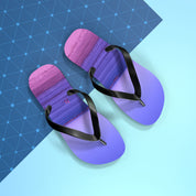 Purple flip-flops with a marbled sunrise pattern on a blue background.