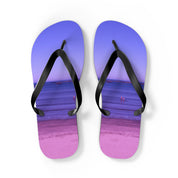 Purple flip-flops with a beach scene and water reflection on the soles.