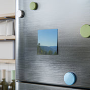 Square magnet featuring a landscape photo of a valley with trees under a blue sky.