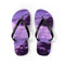 Purple flip-flops with a rocky ocean wave design on a white background.