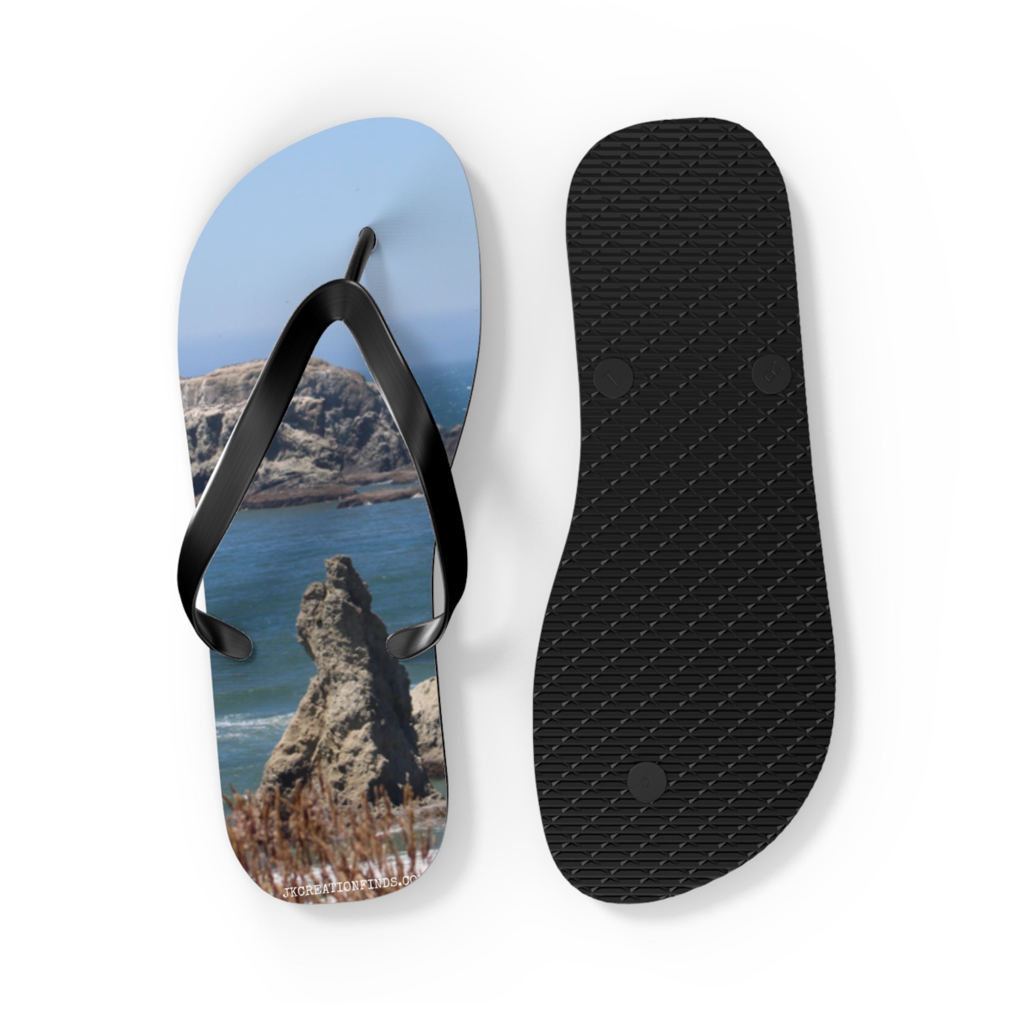 Flip-flops with a rocky coastal landscape print on the sole.