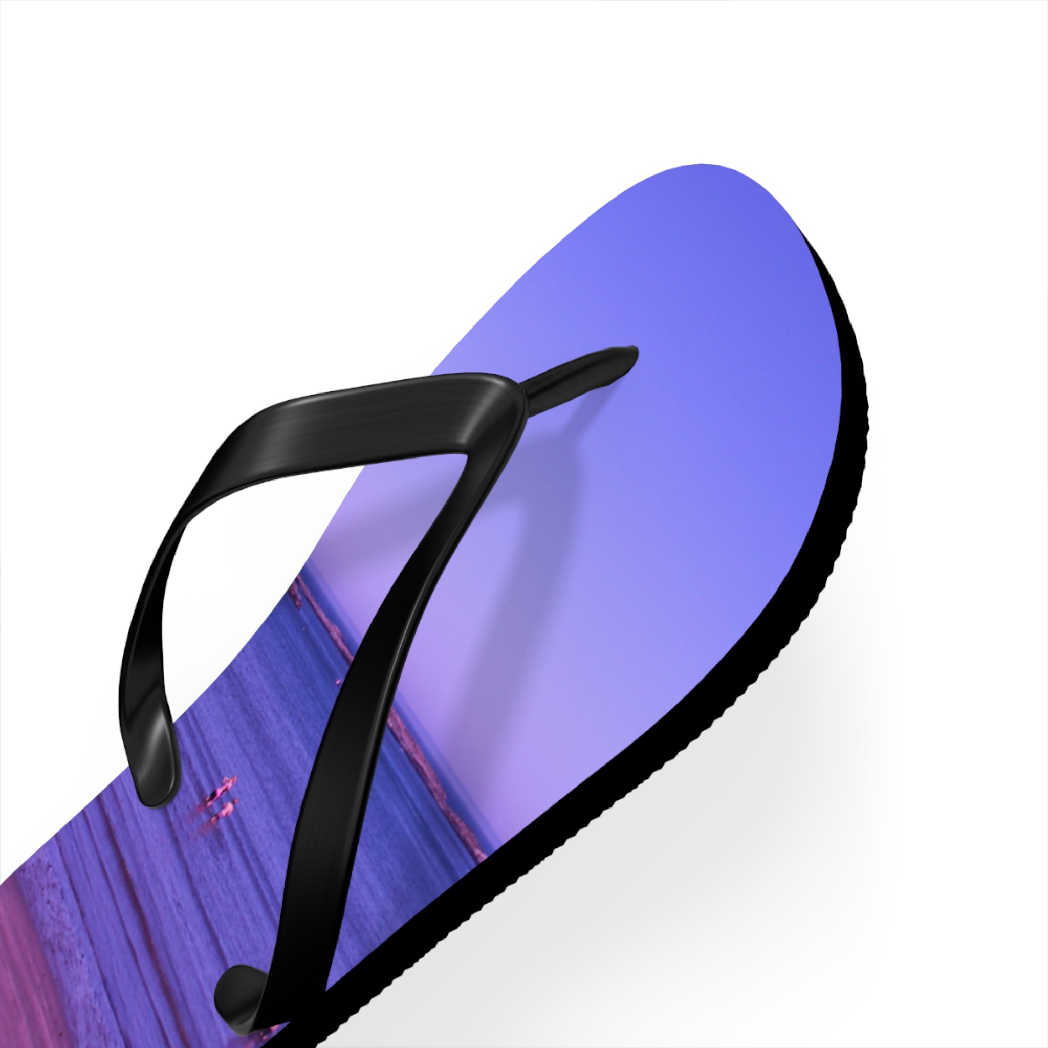 Flip-flops with a sunset beach scene on the soles.