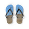 Flip-flops with wind turbines on a grassy hill and blue sky.
