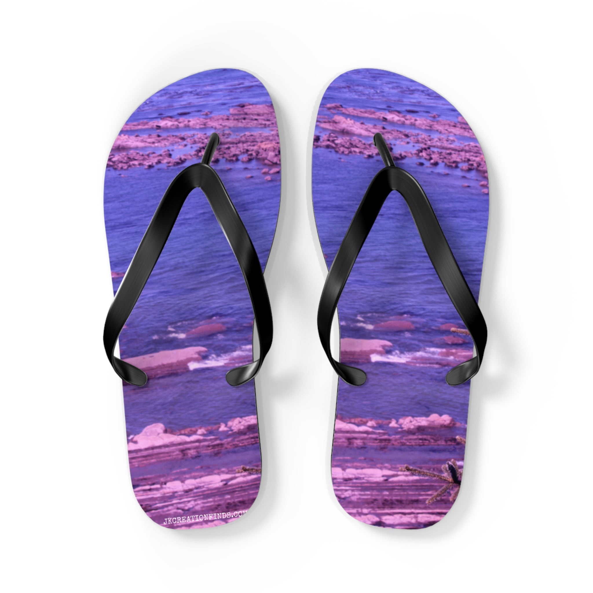 Purple flip-flops with a rocky beach scene on the soles.
