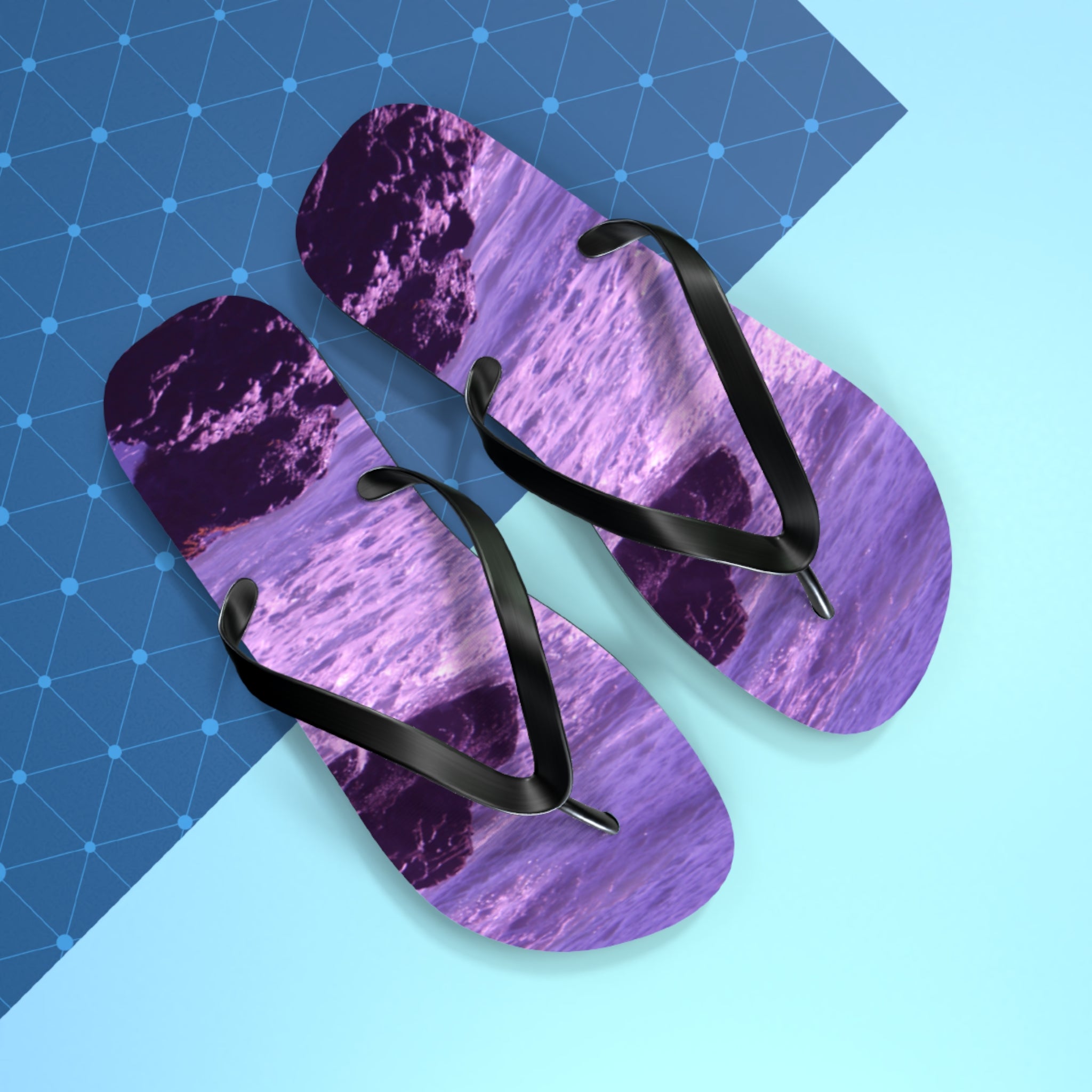 Purple flip-flops with a purple ocean wave pattern.