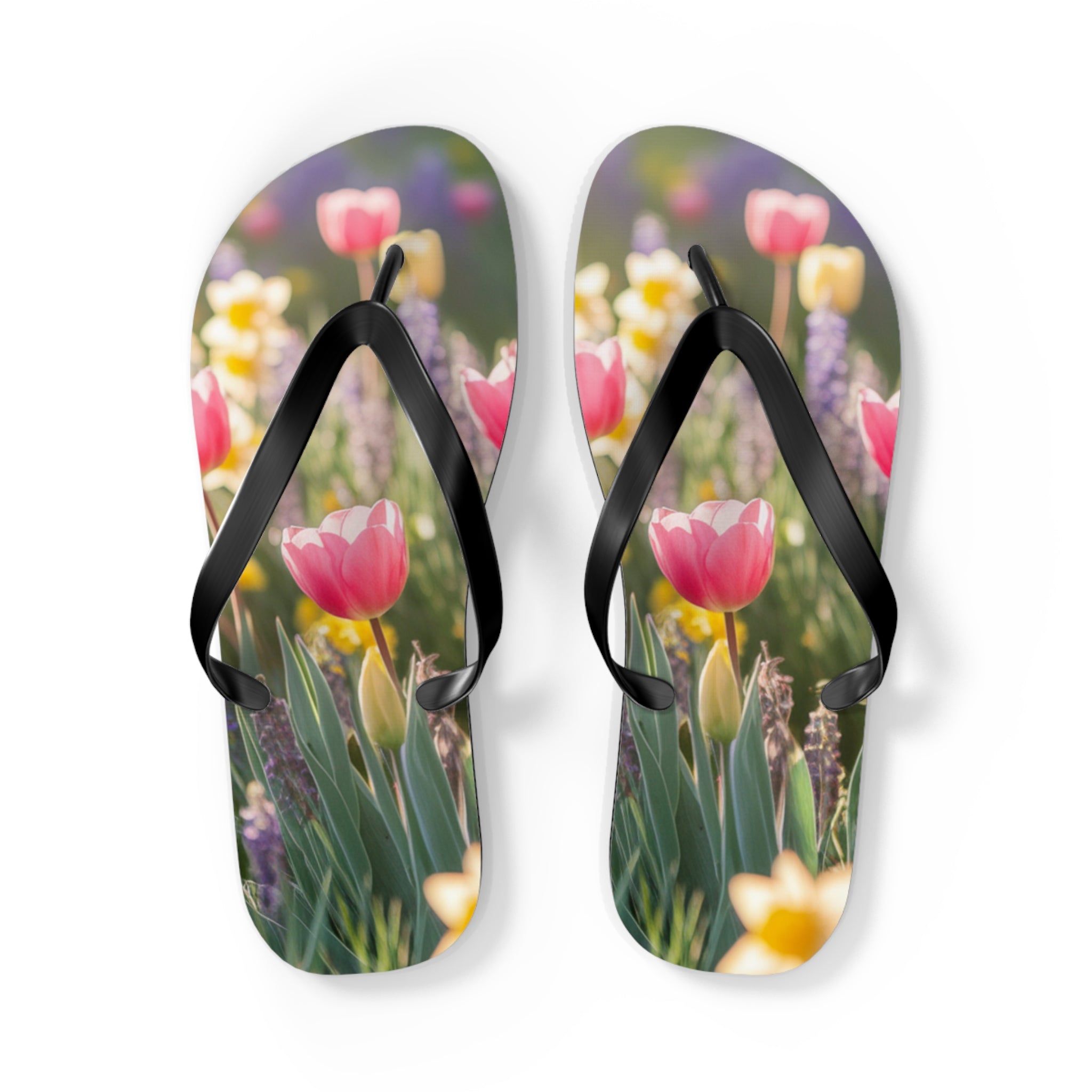 Flip-flops featuring pink tulips and yellow flowers in a garden.