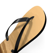 Tan flip-flop with black straps against a white background.