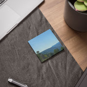 Scenic mountain landscape with trees on a sticky note.