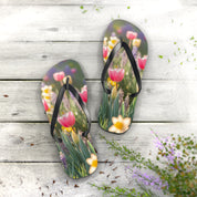 Floral flip-flops with tulips and daffodils on a white wooden surface.