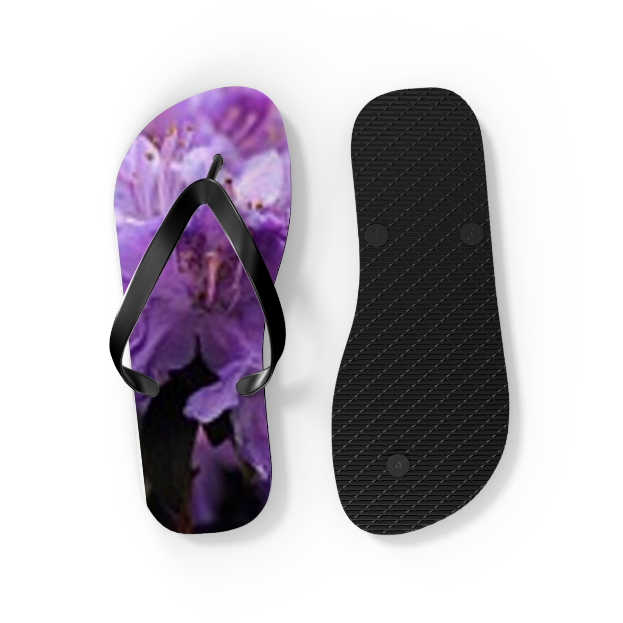 Purple floral flip-flops, one open, one showing textured sole.