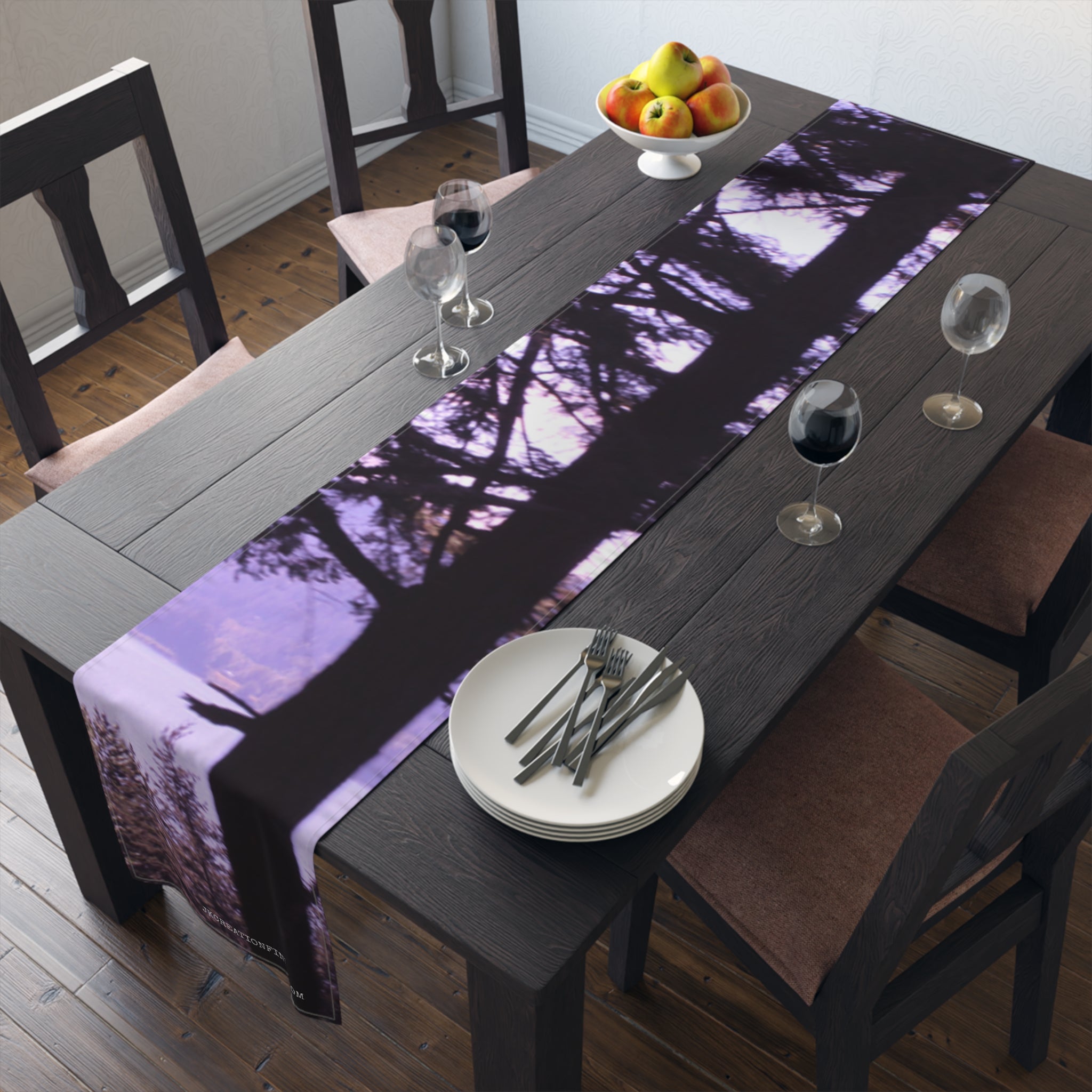Table runner with a forest silhouette and purple gradient.