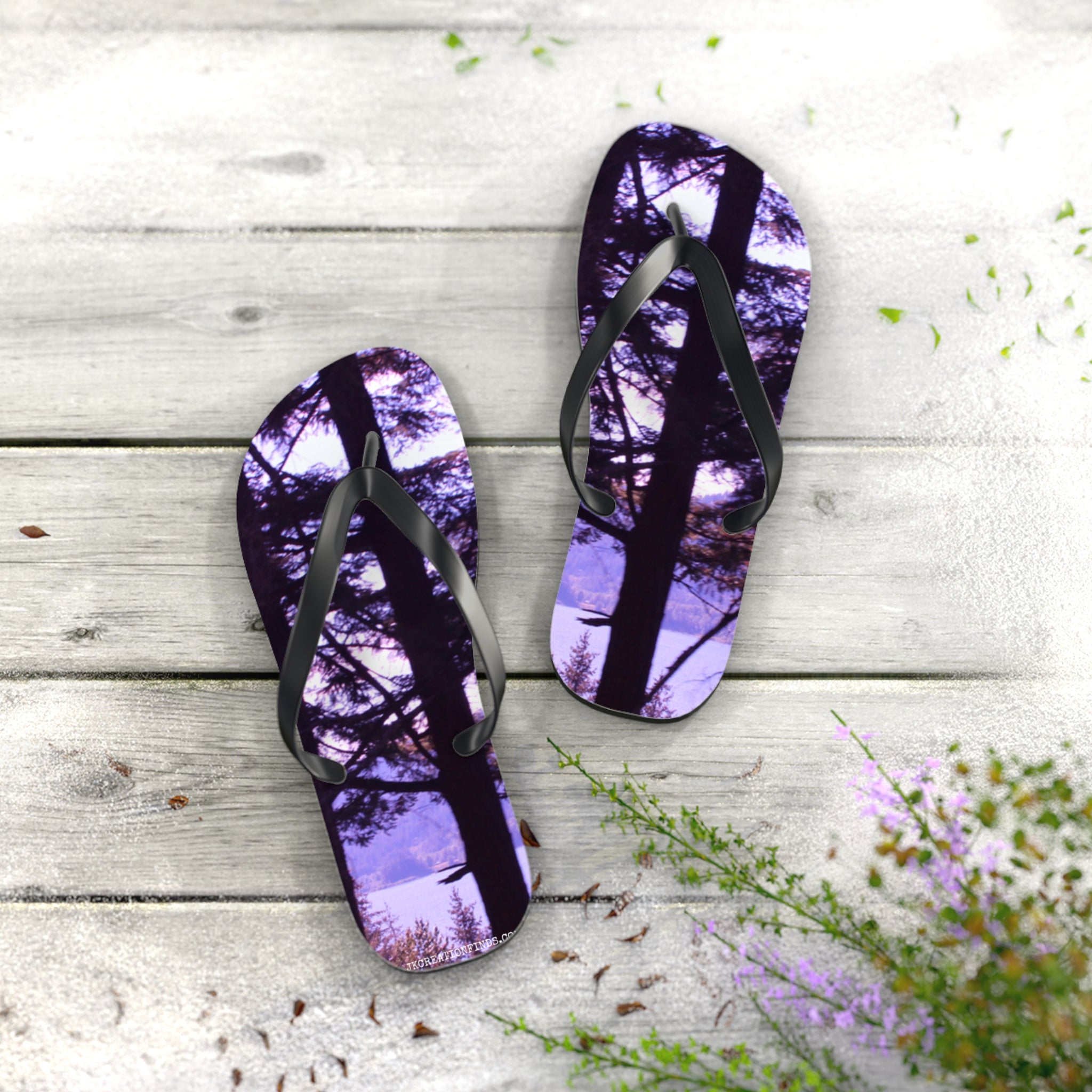 Flip-flops with a serene forest and lake scene printed on the soles.