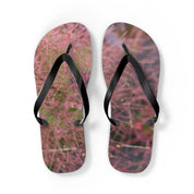 Flip-flops with a fuzzy pink and purple floral pattern and black straps.