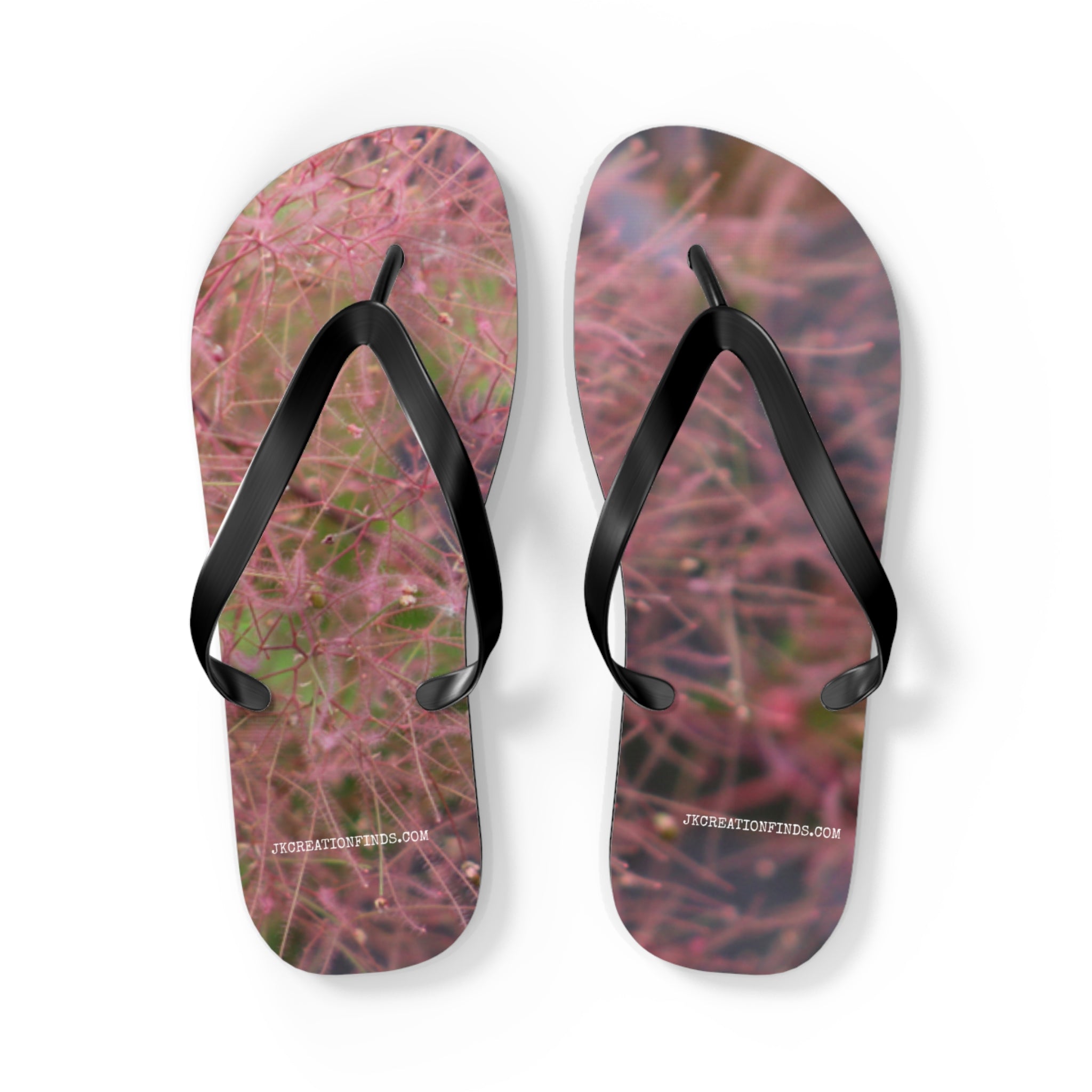 Flip-flops with a fuzzy pink and purple floral pattern and black straps.