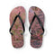 Flip-flops with a fuzzy pink and purple floral pattern and black straps.