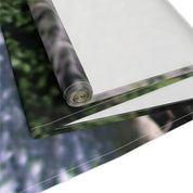 Rolled fabric with a blurred green and purple forest background.