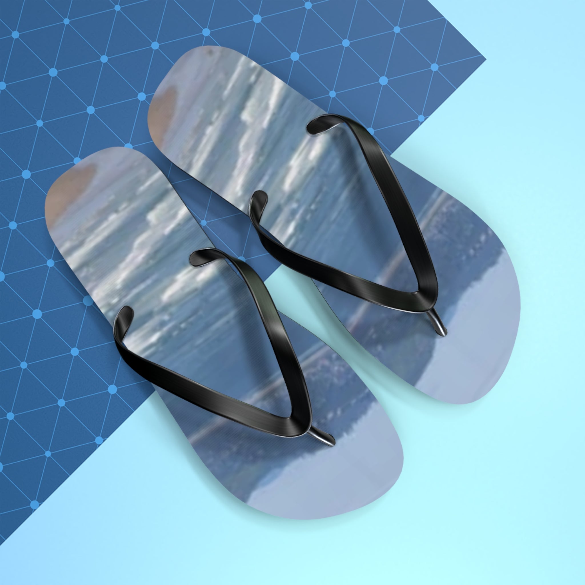 Flip-flops with a landscape print on a blue and white background.