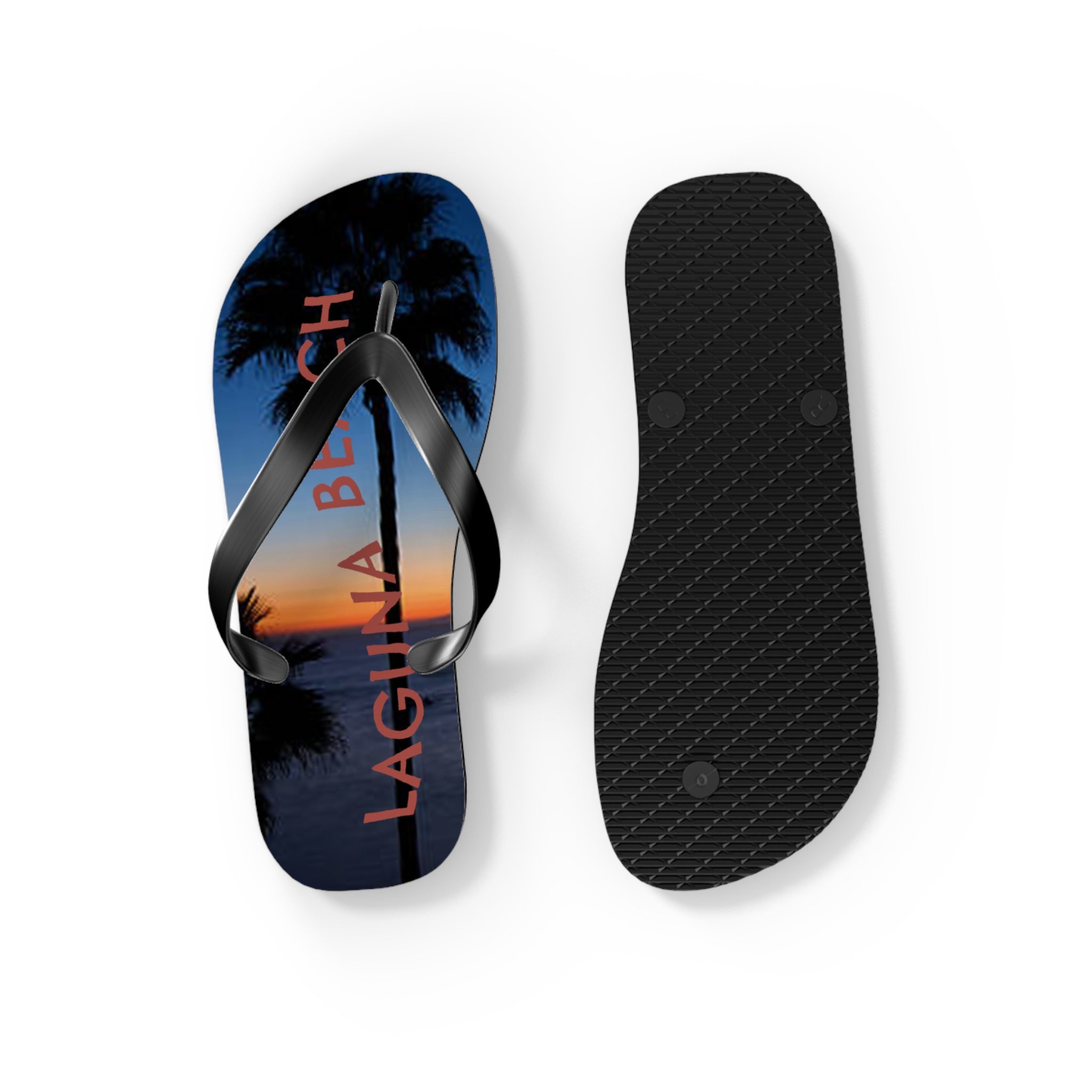 Flip-flops with "LAGUNA BEACH" text and palm tree silhouette at sunset.