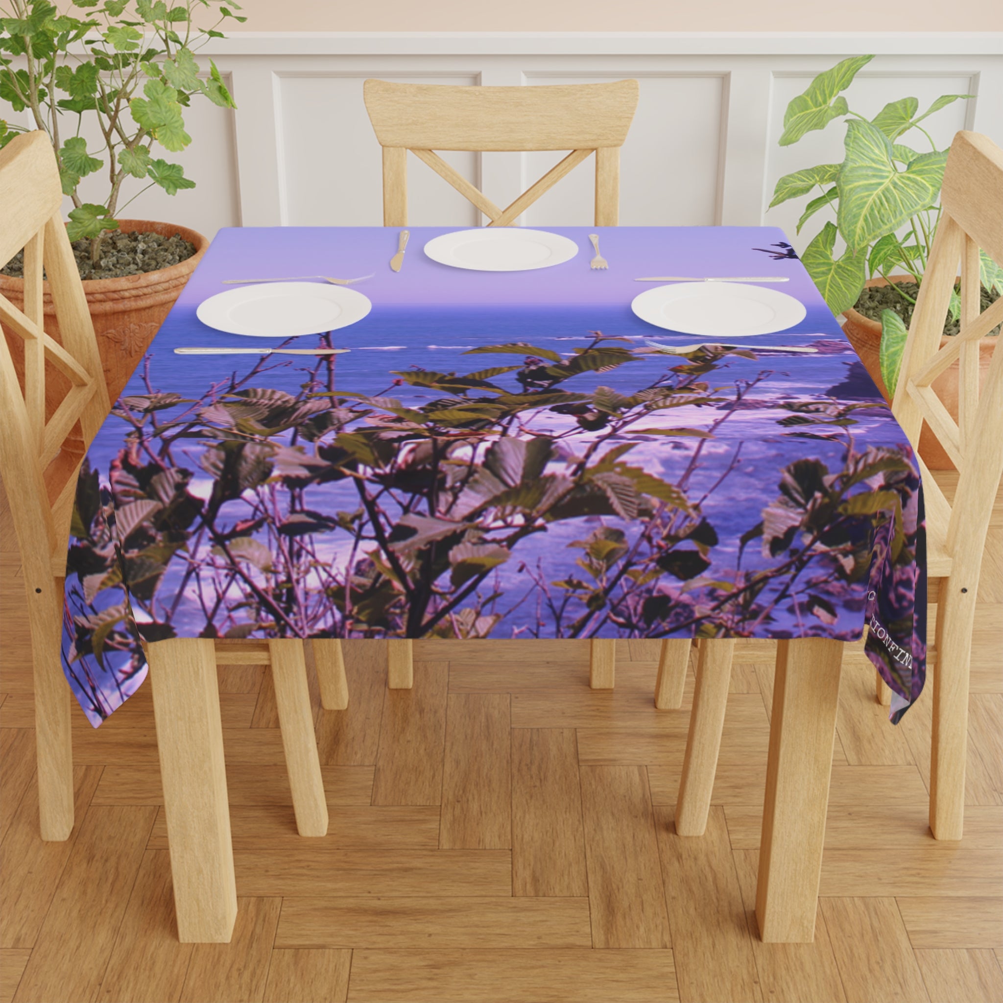 Tablecloth with a close-up view of purple ocean water and green leaves.