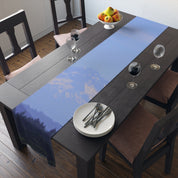 Table runner with mountain landscape pattern, setting for a meal.