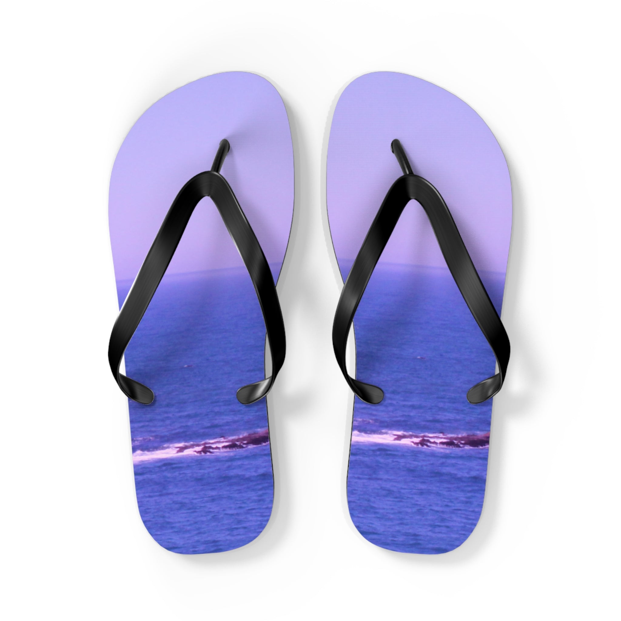 Purple flip-flops with a blue ocean and rock landscape pattern.
