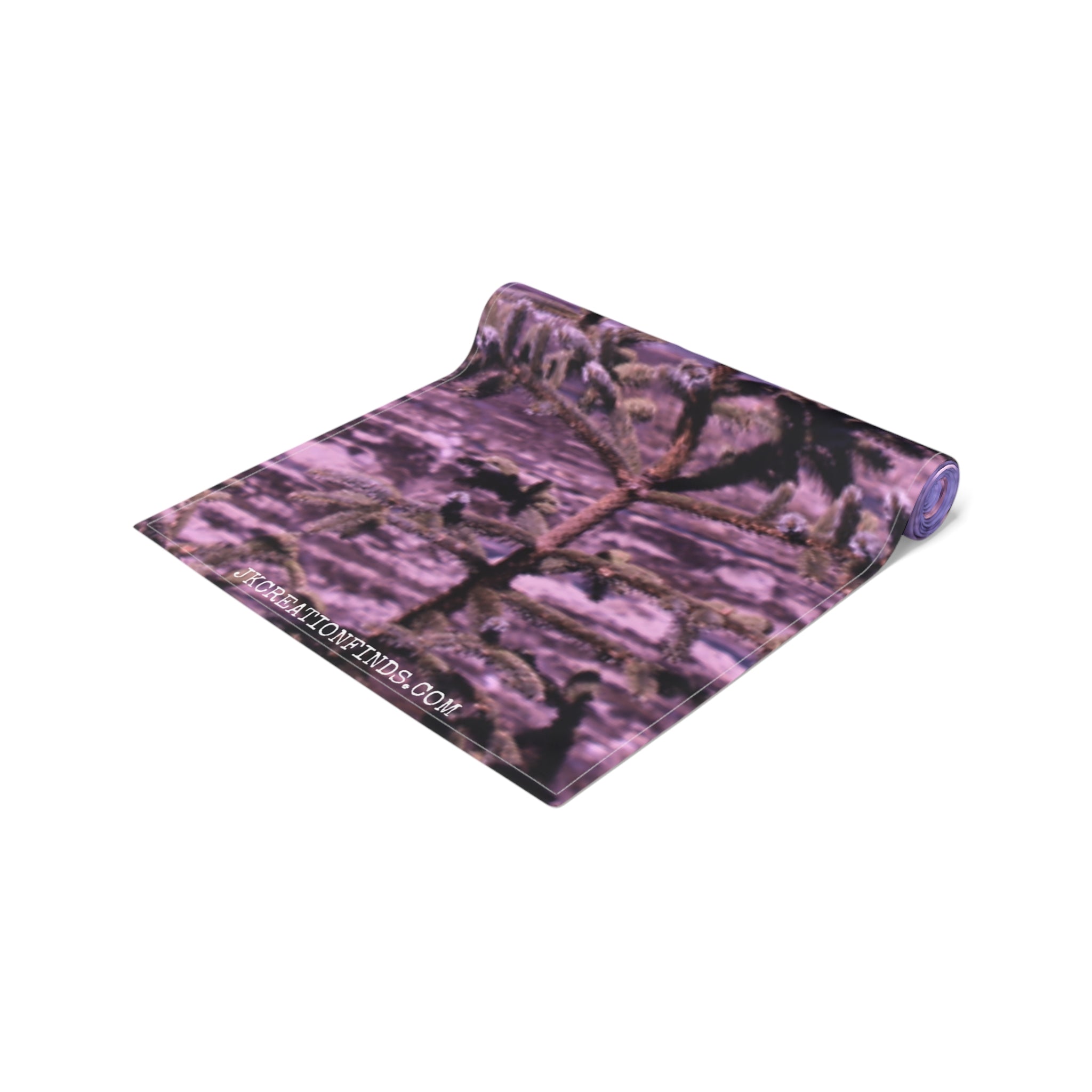 Yoga mat with a blurred purple and green pine tree branch pattern.