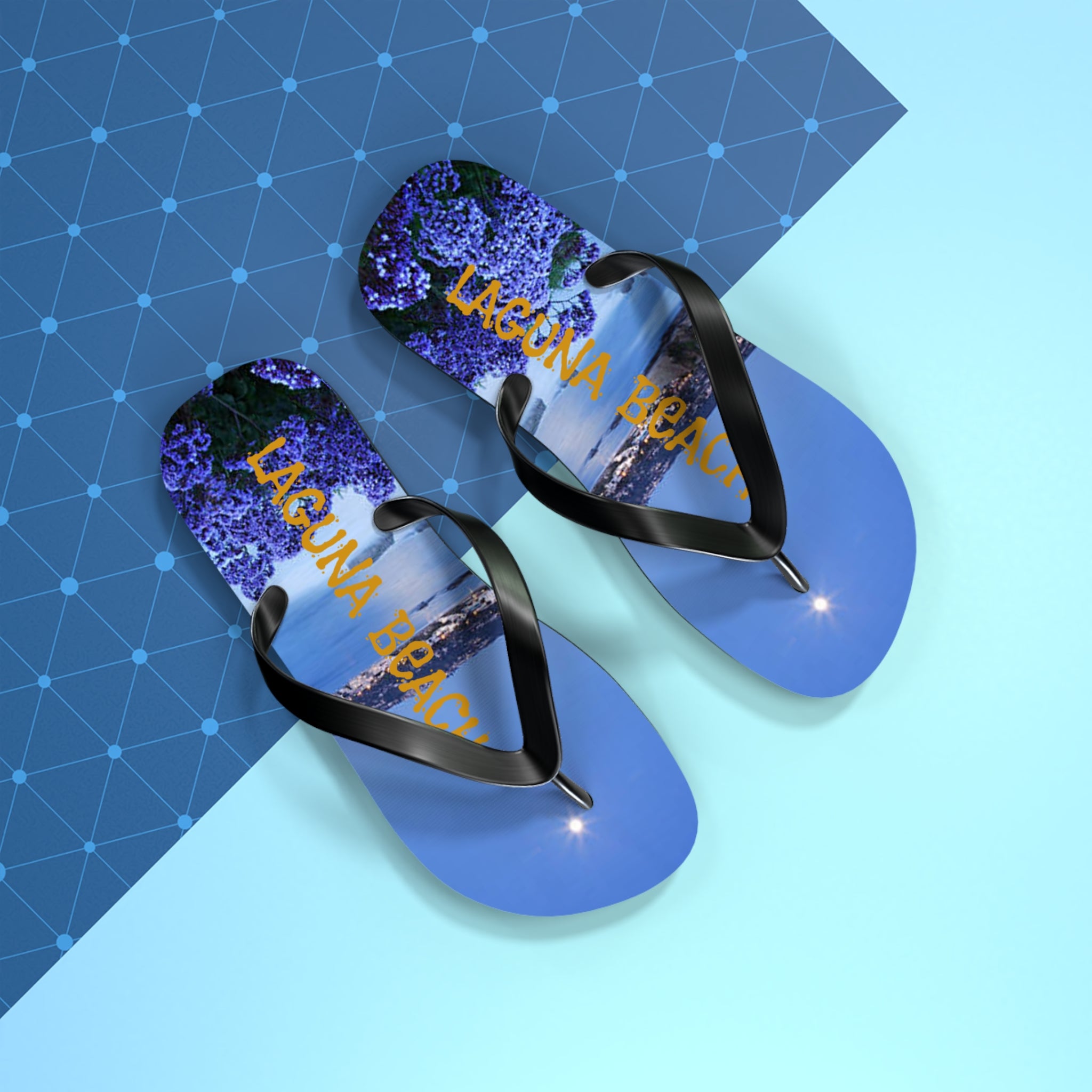 Laguna Beach flip-flops with a scenic beach and flower image.