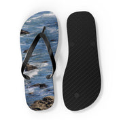 Flip-flops with ocean wave and rocky shore design.