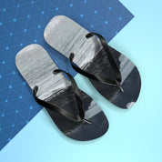 Flip-flops with a scenic mountain landscape on the soles, against a blue background.