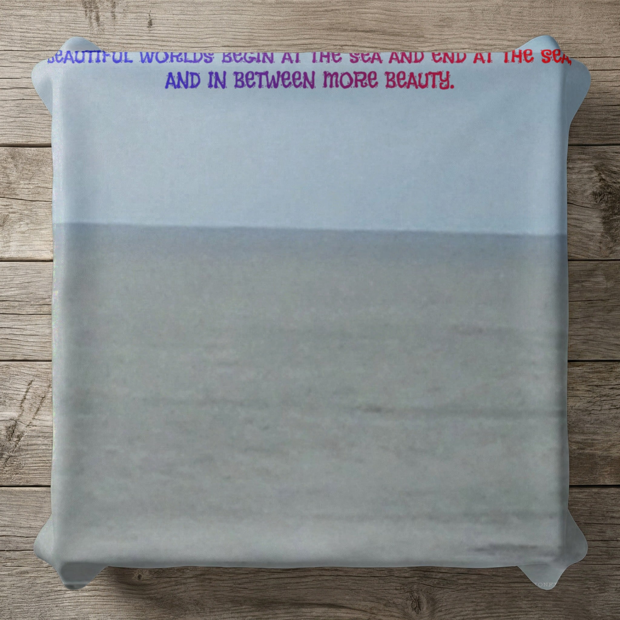 Pillow with text "Beautiful worlds begin at the sea and end at the sea and in between more beauty."