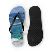 Two flip-flops, one with a beach scene, the other black and plain.