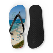 Flip flops with "Laguna Beach" text and ocean view on one sole, black sole on other.