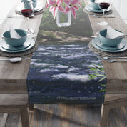 Table runner with blurred river and green foliage design.