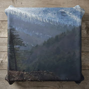 Pillow featuring a misty, forested mountain landscape with pine trees.