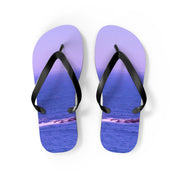 Purple flip-flops with a seascape scene of waves and rocks.