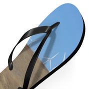 Flip-flop with wind turbines and blue sky on the sole.