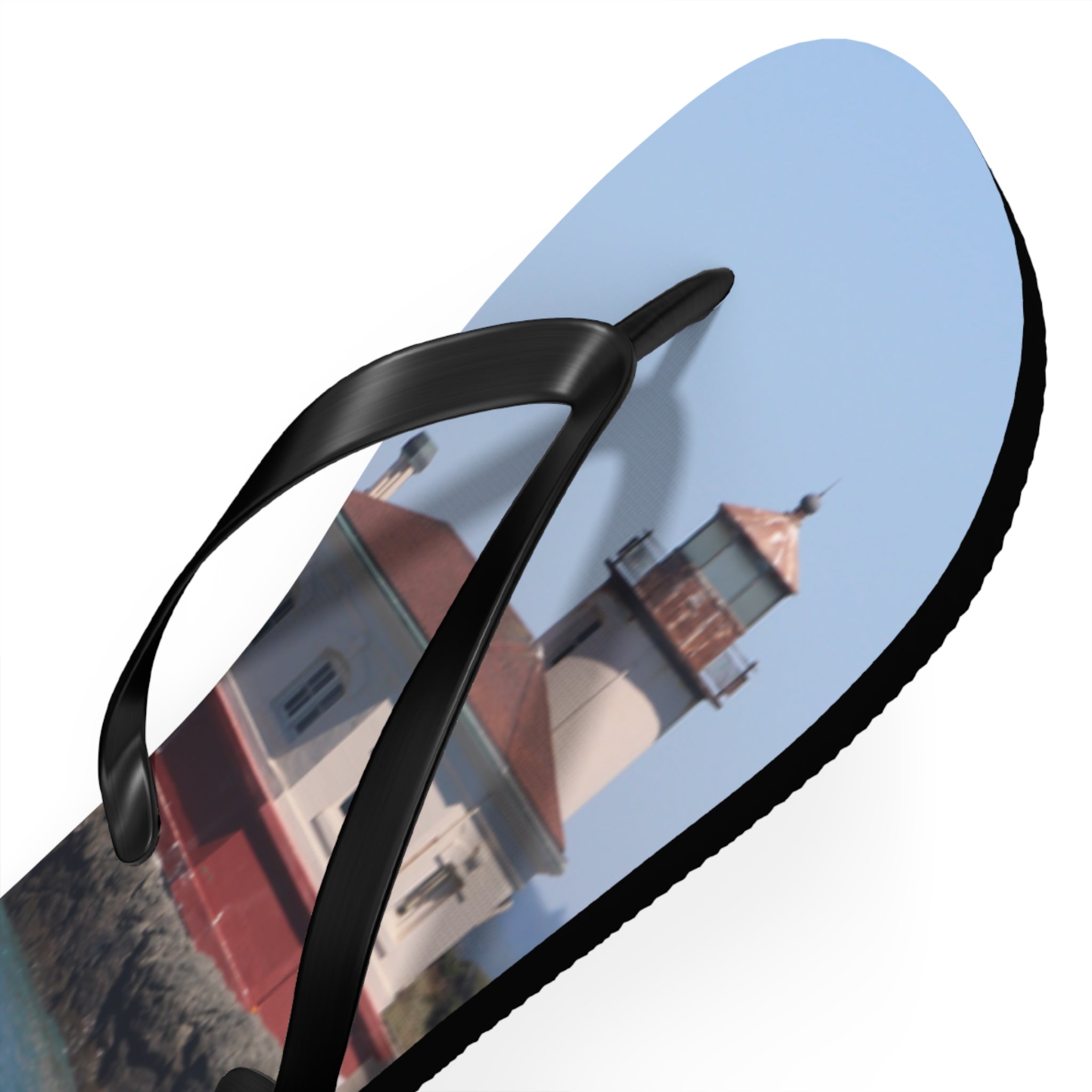 Flip-flops with lighthouse on a sunny day.