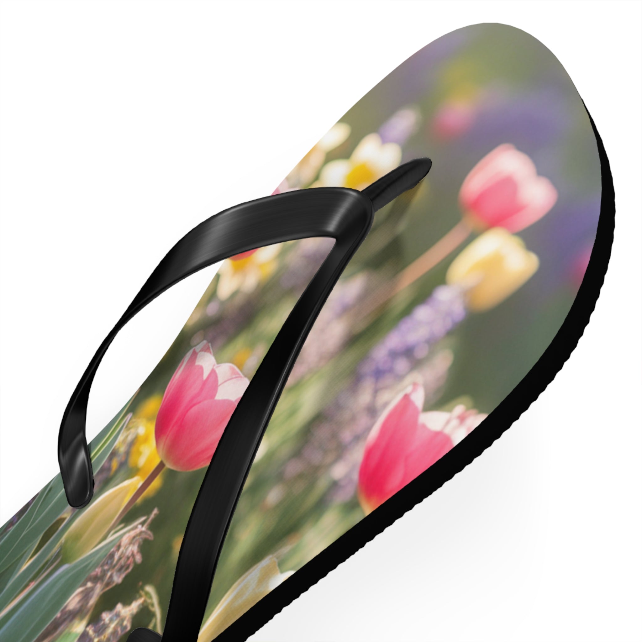 Flip-flops with a close-up floral print of pink tulips and yellow daffodils.